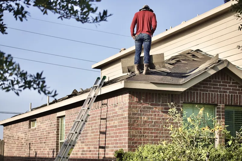 Professional roofer working on a residential roof in Congress Park